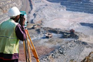 worker measuring the mining pit